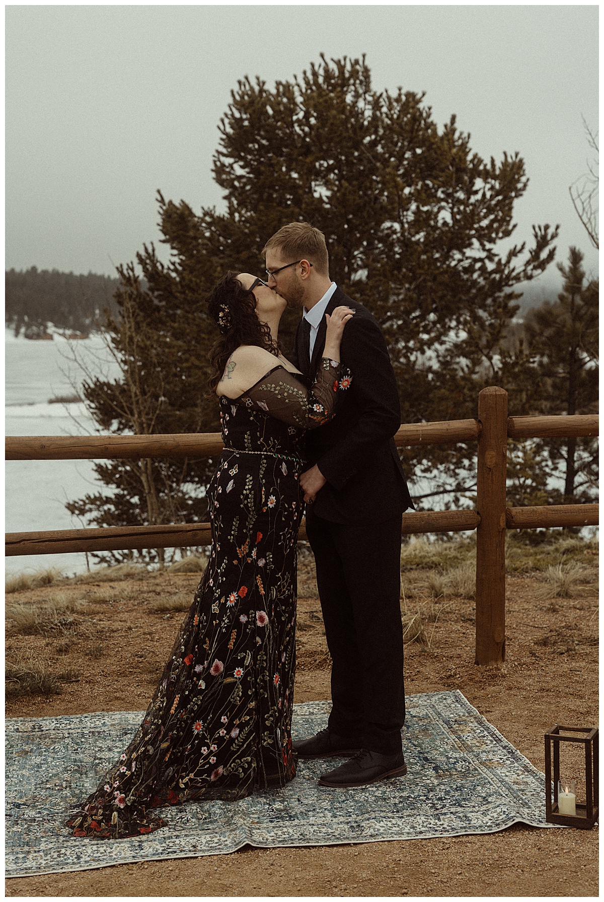 The bride, in her black wedding dress, kisses her groom.