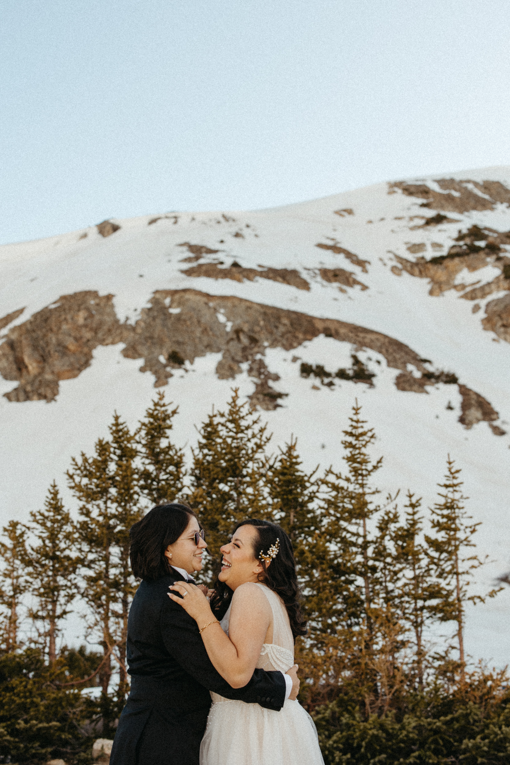 A couple shares a laugh after their small wedding at Loveland Pass.