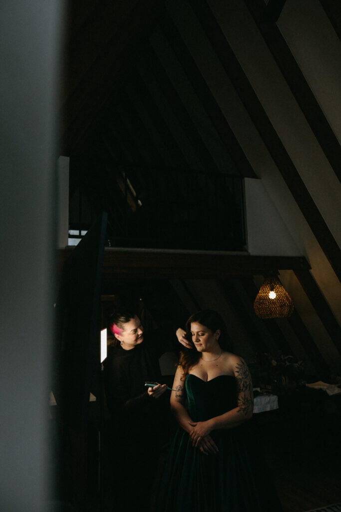 A bride has the finishing touches done to her hair the morning of her wedding.