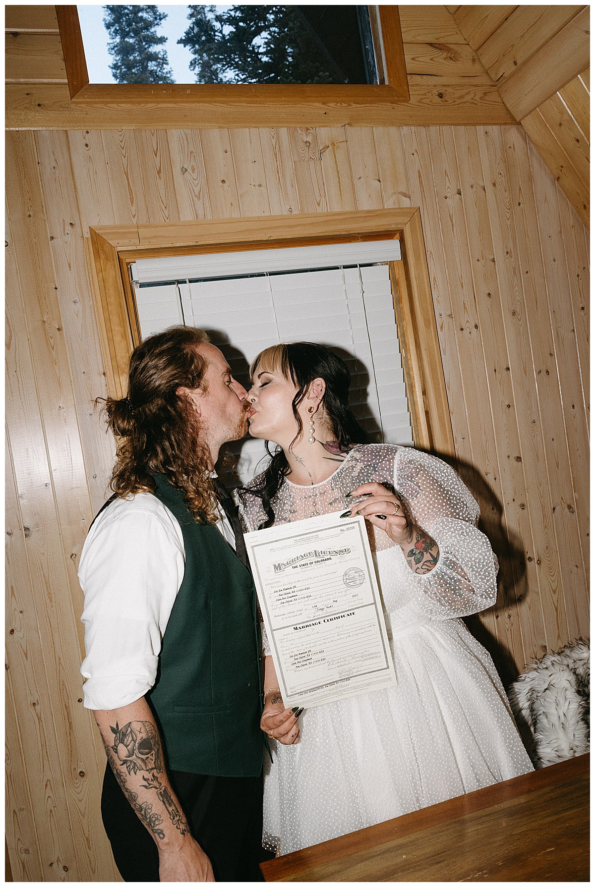 After their A-frame elopement, the couple signs their marriage license.