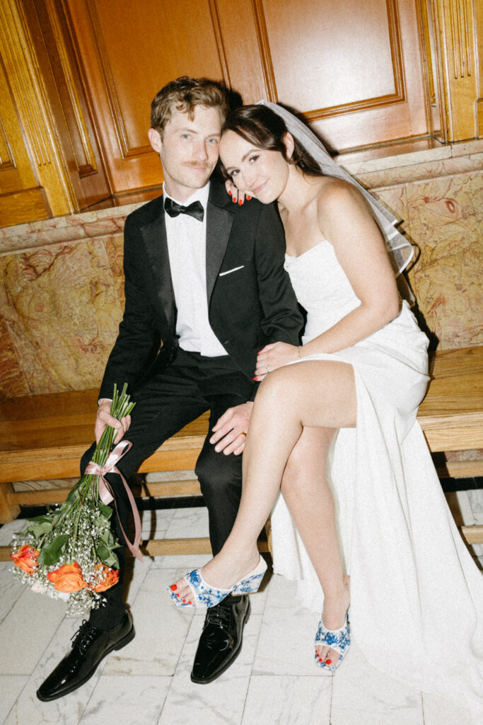 A couple poses together for a wedding portrait in an historic Denver building after their self-solemnization ceremony.