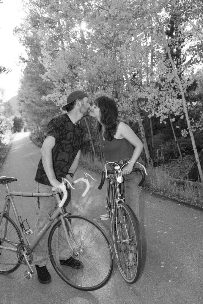 A couple bikes together on vintage road bikes in the fall with Colorado aspens in the background